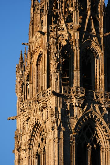 Detail of the north tower of the west facade, a 377-foot (113m) early-16th-century Flamboyant Gothic spire on top of an older tower. Chartres Cathedral, France.