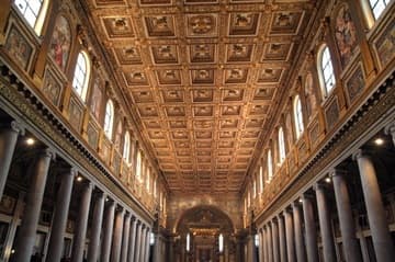The great nave of Santa Maria Maggiore, looking west to the apse. The mosaic panels along the sides date from the 5th century; the rest of the decoration is from the 18th century.