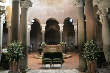 View of the altar area under the dome, decorated for a wedding. Santa Costanza is a very popular wedding venue in Rome. Twelve pairs of Roman columns form an ambulatory around the central area.