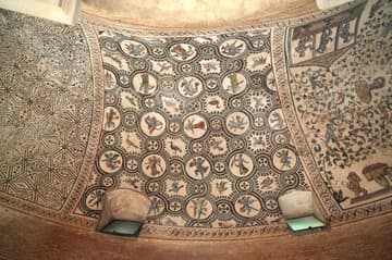 The second mosaic panel on the left from the entrance is a circular motif with animals and human figures.