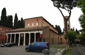 View from southwest as a funeral comes to a close. Many funerals are held at San Lorenzo due to the adjacent municipal cemetery, continuing the ancient tradition of burial near the martyr's grave. Basilica di San Lorenzo fuori le Mura (Saint Lawrence outside the Walls), Rome, Italy.