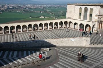 View over the lower plaza of the Basilica di San Francesco, with the town of Santa Maria degli Angeli in the distance.