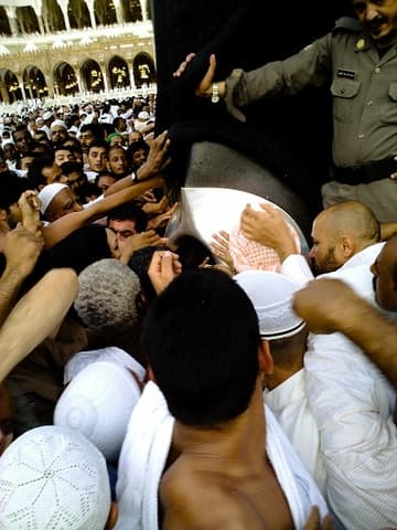 Crowds strain to touch the Black Stone.